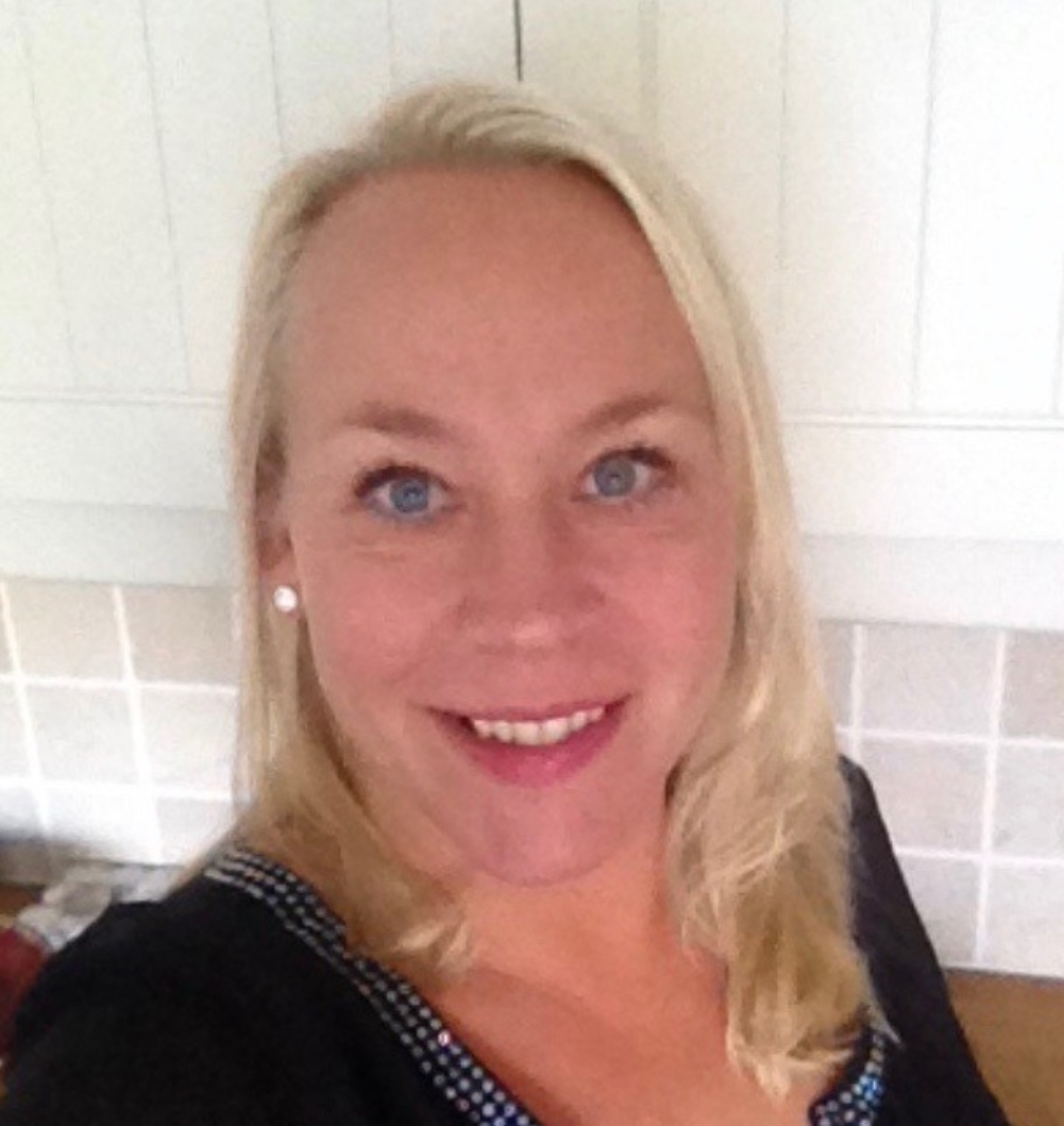 a smiling woman with blond hair